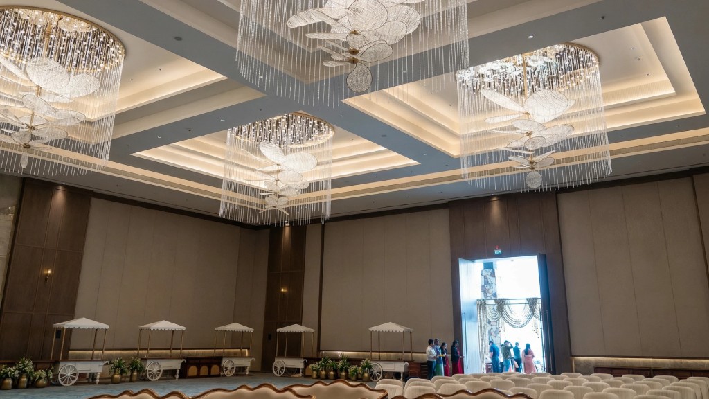 Grand banquet hall interior with chandeliers and food stalls at Beverly Hills