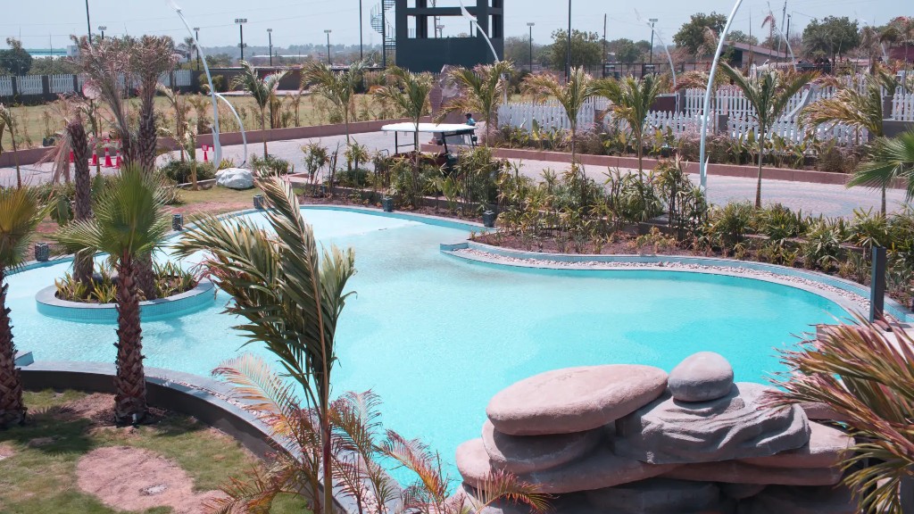 Landscaped lagoon pool surrounded by palms at Beverly Hills Resort