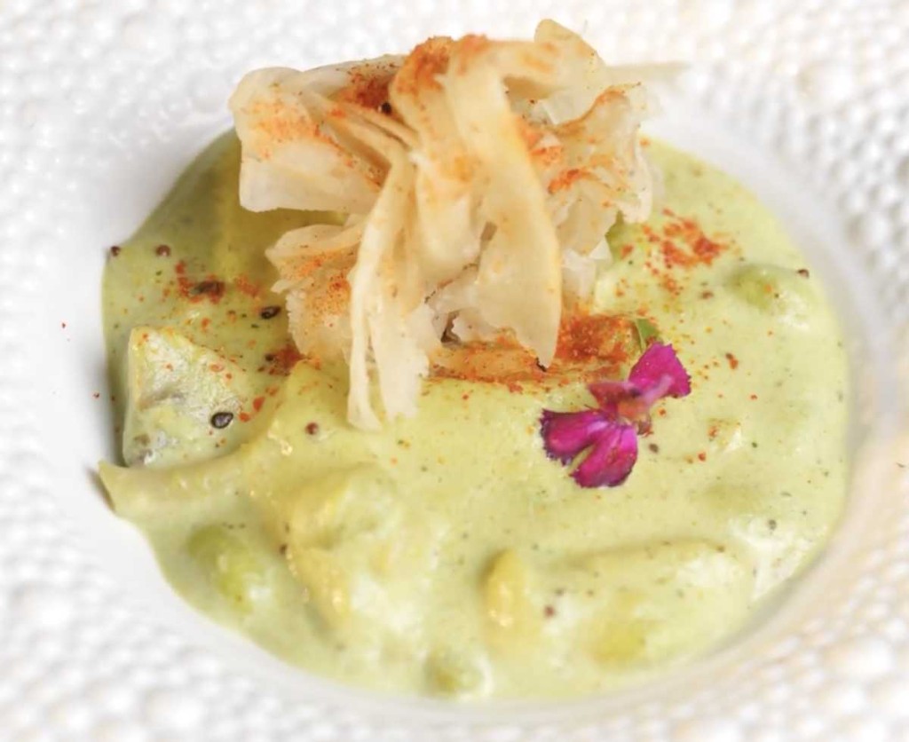 Gourmet plated dish with edible flower garnish