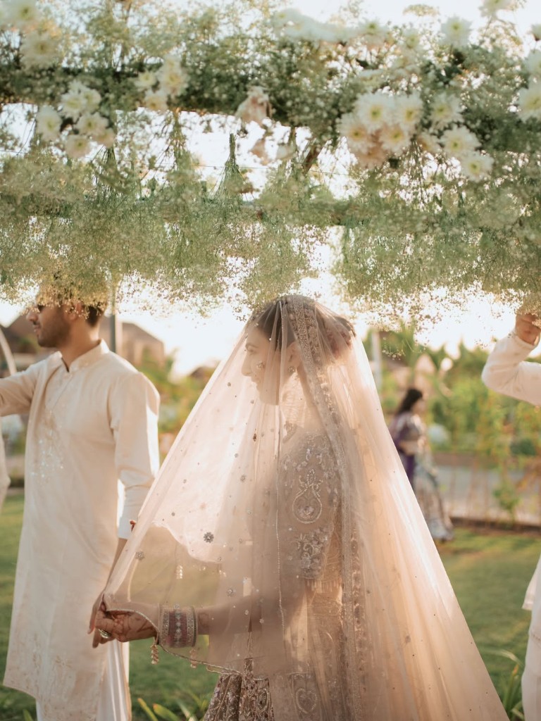 Bride arriving under a floral canopy at Beverly Hills