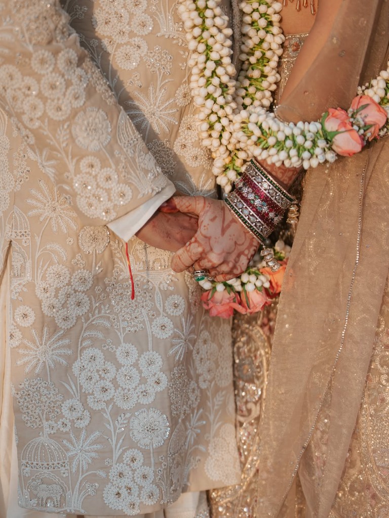 Bride and groom holding hands during wedding rituals at Beverly Hills