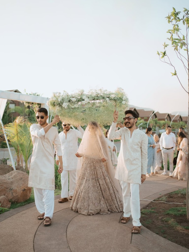 Bridal procession under floral canopy at Beverly Hills